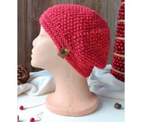 A hand knit red acrylic beanie in a textured stretchy stitch pattern. For winter holiday gifting for kids ages 10, 11, 12, 13, 14.