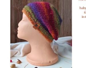A babies & toddlers sized rainbow ombre hat knit with wool. Perfect for winter a gift for a baby or toddler ages 1, 2, 3, 4, 5 years old.