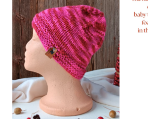 A babies & toddlers sized pink and red hat knit with acrylic. Perfect for winter a gift for a baby or toddler ages 1, 2, 3, 4, 5 years old.