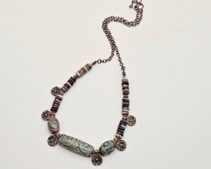 Handmade necklace with Dzi agate beads, mookaite rondelles, and copper accents on a copper chain displayed on a light background.