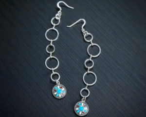 Very pretty pair of dangle earrings. they are western with a concho char,