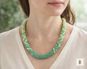 Verdant Fade Kumihimo Necklace by Bead & Braid Collective worn by a model, green ombré beaded necklace showing natural drape