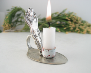 vintage silver plated spoon made into a tiny candle holder