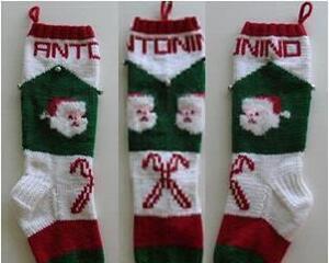 Santa faces and candy canes on hand knit Christmas stocking