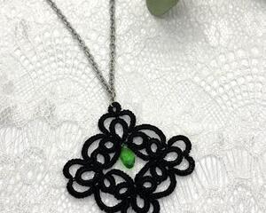 Black lace pendant with faceted green crystal