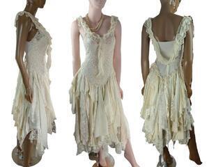A pretty cream lace tattered wedding dress. Crochet style bodice with ruffle around the neckline and extending down the back of the dress. Lace up back for a snug fit. Unique, handmade, eco-friendly bohemian style dress.
