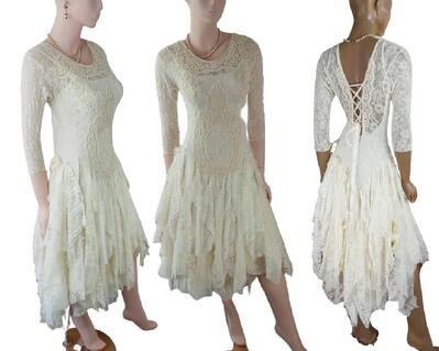 Beautiful cream lace tattered lace up wedding dress. 3/4 lace sleeves and mid-calf high low dress. One of a kind, eco-friendly, handmade, bohemian style dress.