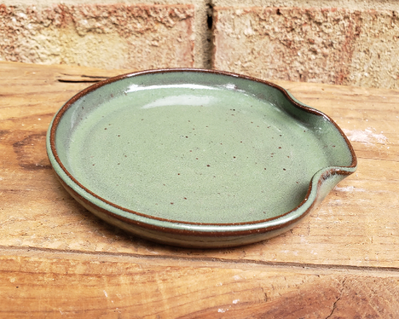 green pottery spoon rest
