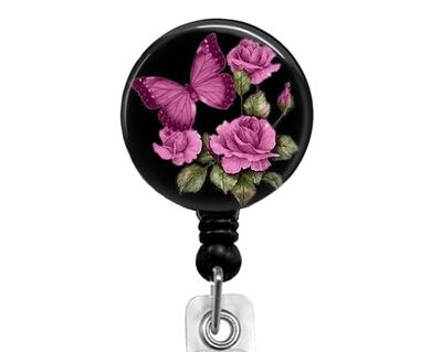 Butterfly and pink roses on a black background affixed to a retractable badge reel.