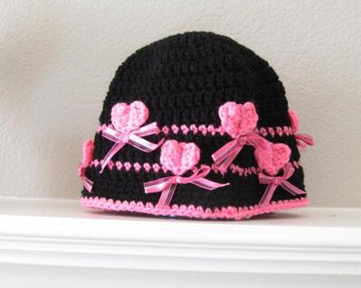 black hat with pink hearts