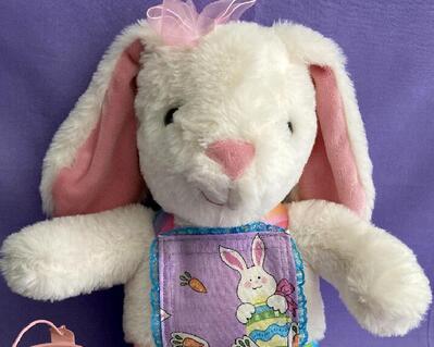 Large female Easter bunny dressed in design and handcrafted pinafore.  She has a metal pink basket filled with Easter eyes.  A nice holiday keepsake. She really is a very cute bunny for a younger girl.  What a lovely gift that will last a lifetime and be remembered  forever and special.