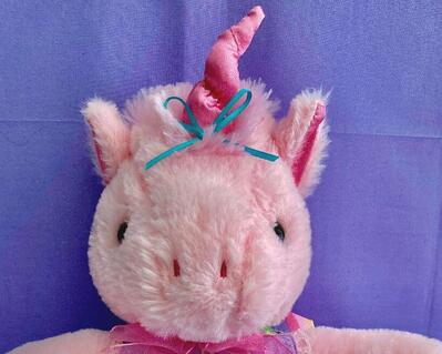 Measurements: 15" head to feet - 14.5" diameter. Unicorn is pink with shades of pink taffeta for horn on her head and for her ears.  She is wearing a pinafore made by Flute Emporium and has a blue metal basket with Easter Eggs situated next to her.  A cute collectible for a flutist or with a flute.