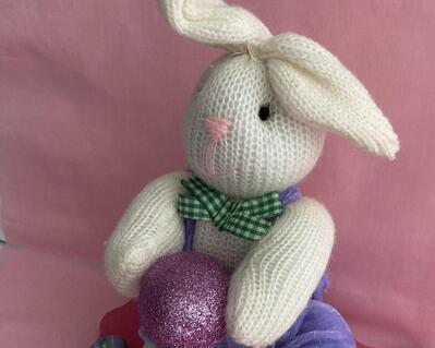 Measurements: Bunny 9" tall  x 4" wide - Plaque 7.5" length x 5" wide. Cute sock bunny seated on a decorative pink base adorned with Easter eggs and hold a large glitter eg.  Wonderful Bunny for a centerpiece for the special holiday