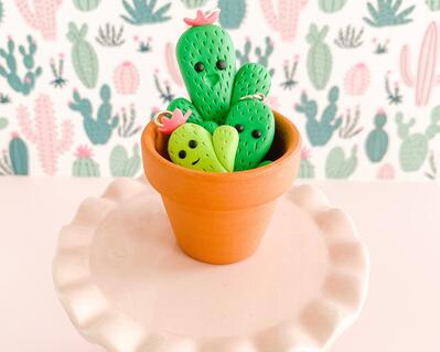 fireflyFrippery Kawaii Cactus Charms in Miniature Terra Cotta Pot on Pink Display
