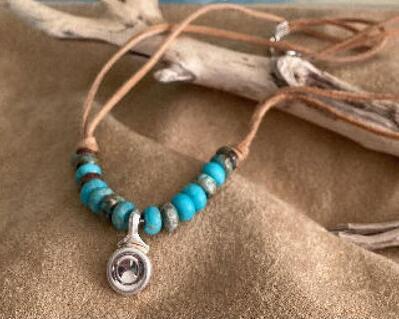 Gorgeous necklace designed in southwest motif.  Stunning silver flute key become a pendant. This beautifully designed necklace shows the real beauty of Turquoise  beads and suede cord from our Native Americans Ancestry.