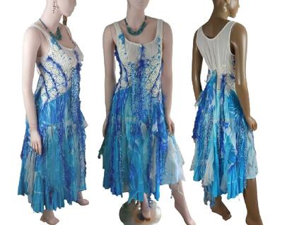 A unique Cobalt blue and white beach style wedding dress. Features crochet bodice with a lace up front. A tie up around the waist. Lots of interesting fabrics in the skirt. One of a kind, hand made, eco-friendly bohemian style dress.