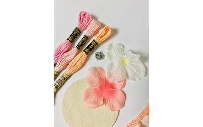 Made with embroidery floss, flower petals, and felt