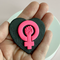fireflyFrippery hot pink feminist fist on black heart background pin in hand