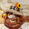 Scarecrow head with sunflower ribbon side view