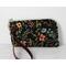 This wristlet using a cute floral canvas print, is perfect to carry by itself on in a bigger purse. It comes with two card slots inside and a zipper pocket for coins. The zipper wraps around two sides, which makes it easy to access and see what's inside.