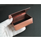 Inside of solid copper trinket box 3" x 2" with enameled lid with silhouettes of trees and running wolves