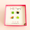 Set of four stud earrings - a four leaf clover, pot of gold, half a rainbow and three leafed shamrock - on a fireflyFrippery branded jewelry card in a hot pink square box