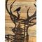 This picture shows the deer head portion of the wall hanging. A silhouetted forest of fir and pine trees is burned inside the deer outline. 