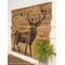 This image shows a deer silhouette wood burned onto an old fence. It is a large square statement piece for a rustic home. 
