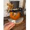 This shows Thisbe the pumpkin gourd and me holding the battery-operated candle that comes with your purchase.