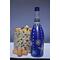 Hand painted blue bottle with various dot art/mandala designs around the entire bottle