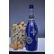 Hand painted blue bottle with various dot art/mandala designs around the entire bottle