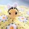Miniature Bumblebee Plushie displayed on yellow fabric with white daisies