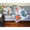 Handmade quilt, 44 X 58, various modern print fabrics in teal, burnt orange, black and ivory on white, floral backing; comes with 20" matching pillow
