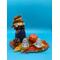 Base 8" x 5" X .125" country flutist in denim and plaid outfit.  She is attached to an orange bas with fall flowers, pumpkin, pine cone and set of salt and pepper shakers nestled in small containers to keep then sale as they go around the table.  Cute centerpiece!