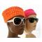 Mannequins are wearing pillbox-inspired hat in hot pink and bright orange.