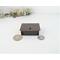 photo of copper trinket box next to quarter and dime for size relation