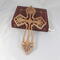 This Ten-Inch Rustic Fretwork Christian Cross Wall Hanging Art is handcrafted from reclaimed wood. Its intricate fretwork design adds unique texture and character, blending rustic charm with elegant design. It is a perfect focal point for any room.