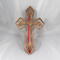 This Ten-Inch Rustic Fretwork Christian Cross Wall Hanging Art is handcrafted from reclaimed wood. Its intricate fretwork design adds unique texture and character, blending rustic charm with elegant design. It is a perfect focal point for any room.