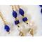 Long dangling blue glass earrings, with gold tone accents.