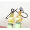 Close-up view of tiny opal beads, atop a pair of gemstone flower dangle earrings.