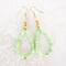 Handmade green opal beaded dangle earrings, with gold crystal accents.