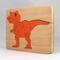 Handmade Wood Dinosaur Tray Puzzle with Amber Shellac and Orange Paint Finish. Freestanding and Versatile Toy for Kids of All Ages, Crafted in the USA with Traditional Woodworking Tools.