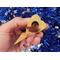 The wooden miniature Birdhouse Ornament is shaped like a heart. A small, dark-reddish-brown bird is perched on the front of the birdhouse. The heart-shaped structure has a pointed bottom that tapers down to a fine point. The wood is light beige.