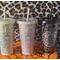 A 24oz matte cold cup in each color available: Black, Grey, and Mint.  They all feature the Spooky Doodle background in silver vinyl. Leopard print background.