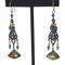 Long, boho dangle earrings, with blue and topaz crystals, shown on a display stand.