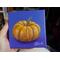 Photo of small square canvas painting of orange pumpkin with purple blue background