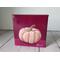 Photo of small square canvas painting of peach colored pumpkin with a raspberry pink background