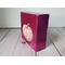 Photo of sideview of small square canvas painting of peach colored pumpkin with a raspberry pink background