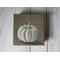 Photo of small square canvas painting of white pumpkin with a light brown background