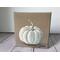 Photo of small square canvas painting of white pumpkin with a light brown background